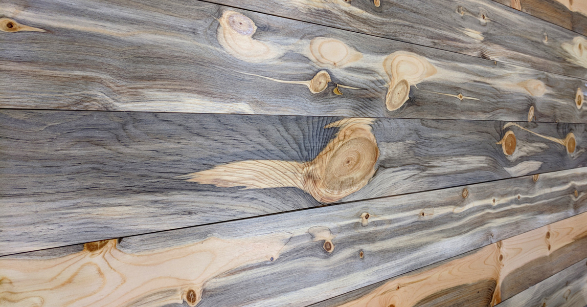 A reclaimed beetle-kill pine plank with characteristic blue-grey fungal stain streaking through the grain.