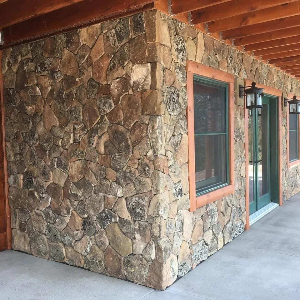 A Colorado moss rock veneer face with intact lichen and moss patina.