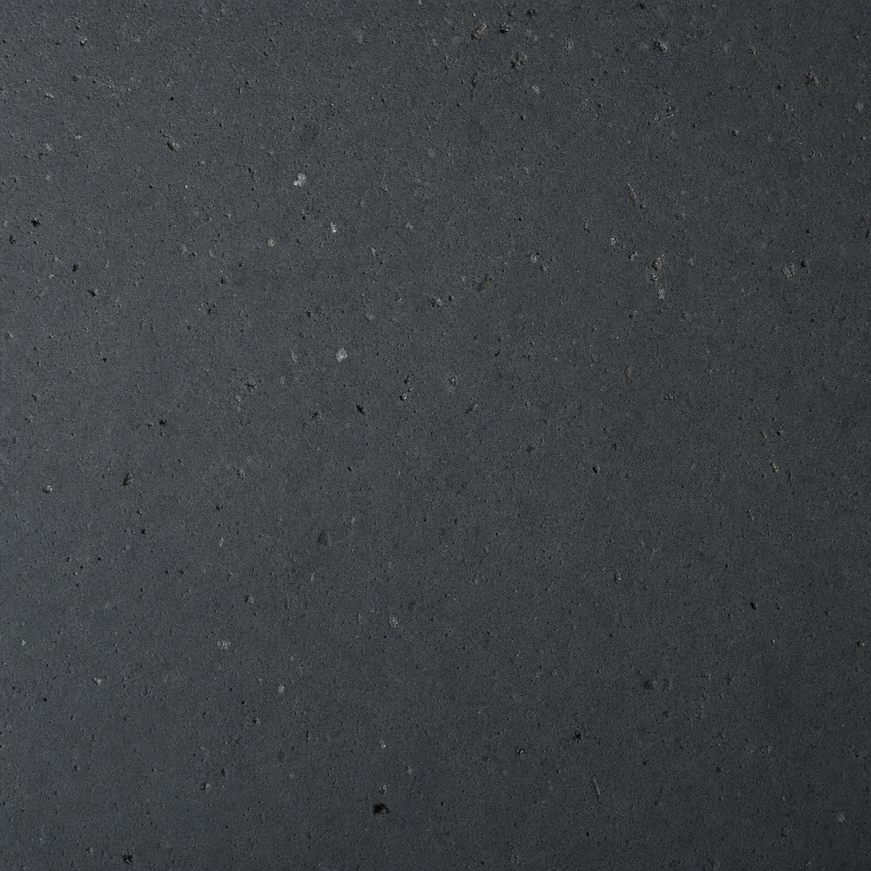 A swatch of honed volcanic basalt in deep matte charcoal.