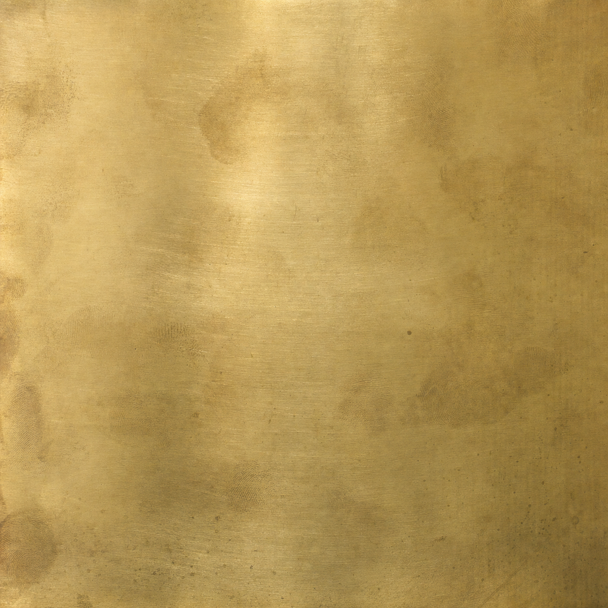 A swatch of unlacquered brass with living patina.