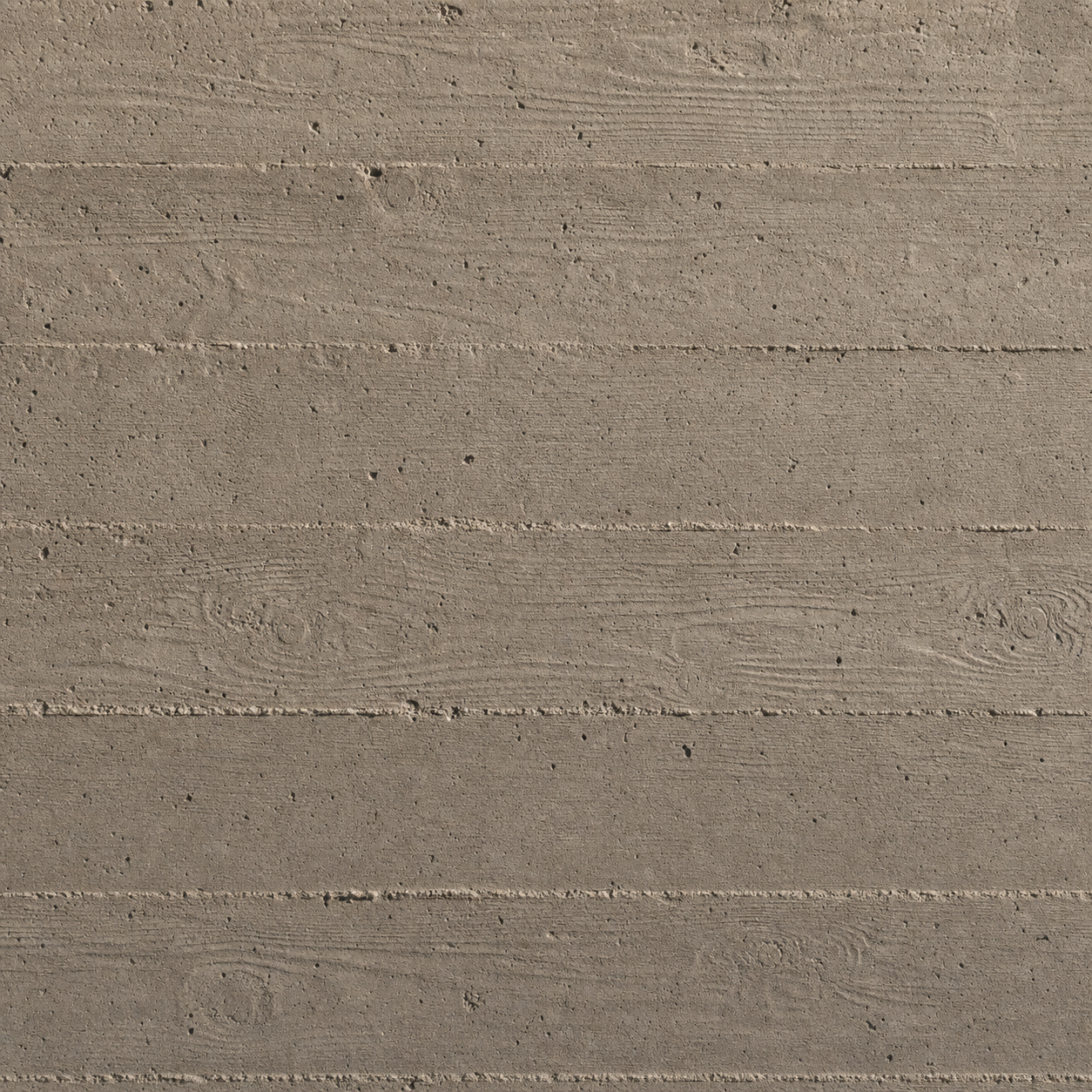 Board-formed concrete surface with the impressed grain of pine boards visible across the cured face.